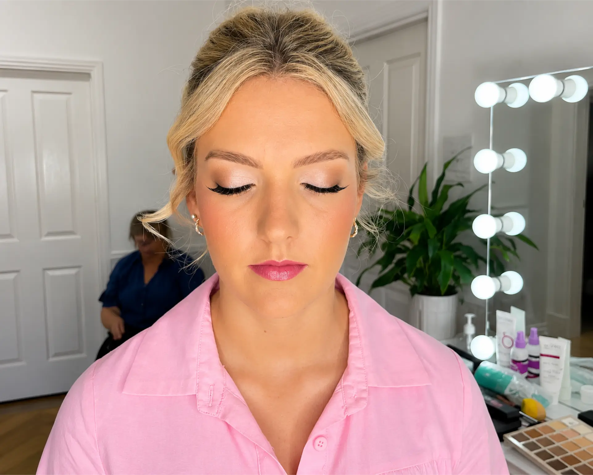 Therapist applying makeup to a client at Erikka's All Occasion Beauty